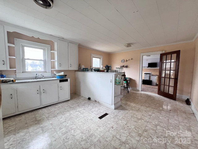 930 Weaver Rd, China Grove, NC 28023 - kitchen with open shelves, light floors, plenty of natural light, and a peninsula
