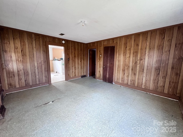 930 Weaver Rd, China Grove, NC 28023 - empty room featuring baseboards, wood walls, visible vents, and tile patterned floors