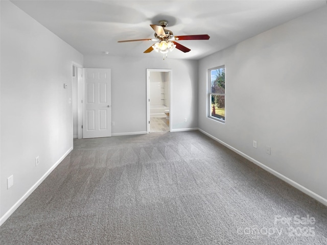 unfurnished bedroom featuring ceiling fan, carpet, connected bathroom, and baseboards