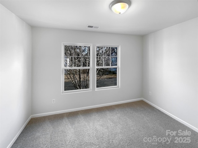 carpeted empty room with visible vents and baseboards