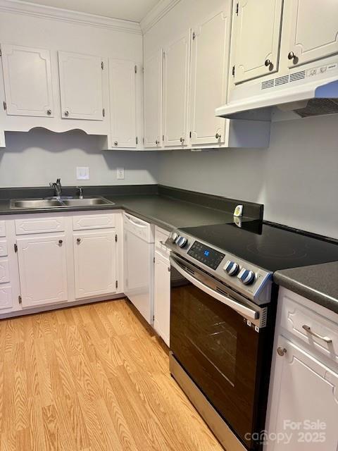 kitchen with dark countertops, stainless steel range with electric cooktop, a sink, white dishwasher, and under cabinet range hood