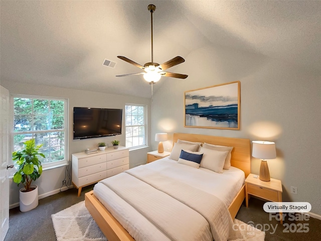 carpeted bedroom featuring visible vents, baseboards, vaulted ceiling, and a ceiling fan