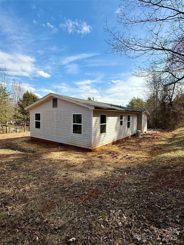 view of side of property featuring crawl space and central AC