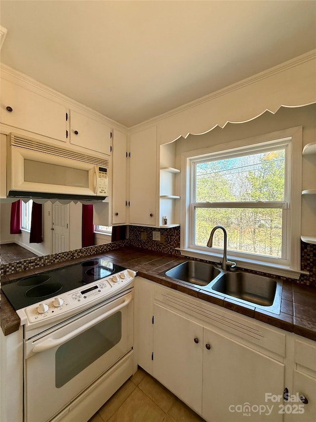 kitchen with open shelves, white appliances, a sink, and white cabinets