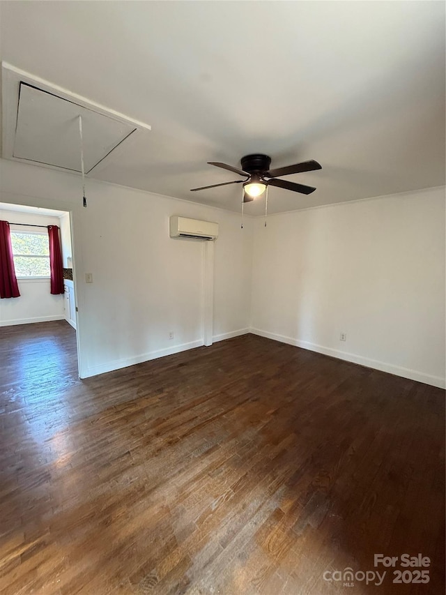 empty room with ceiling fan, dark wood-type flooring, a wall mounted air conditioner, and attic access