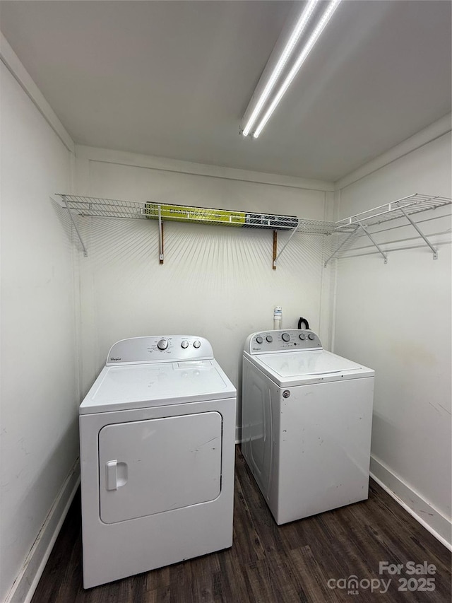 washroom with baseboards, laundry area, dark wood-style flooring, and washer and dryer