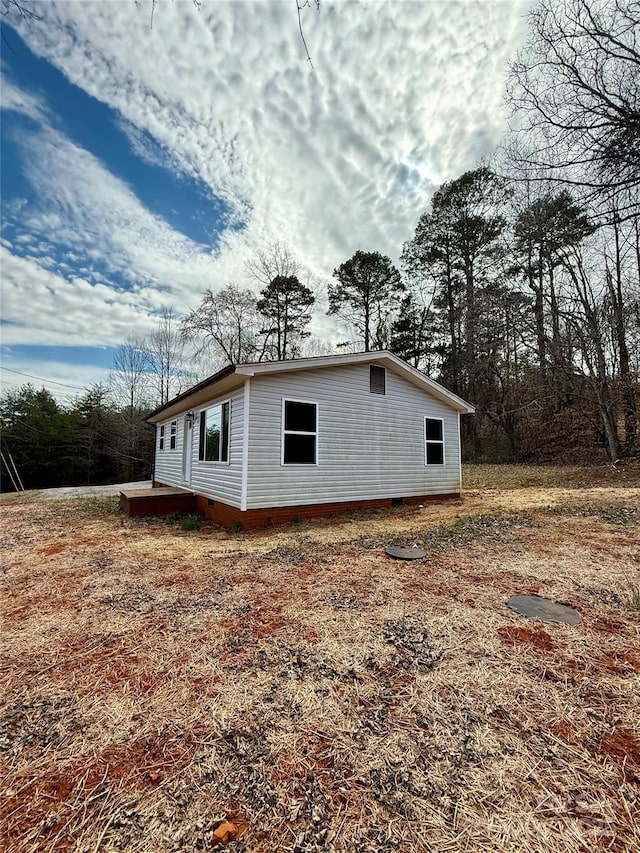 view of side of home with crawl space