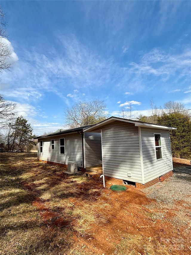 rear view of property featuring central air condition unit