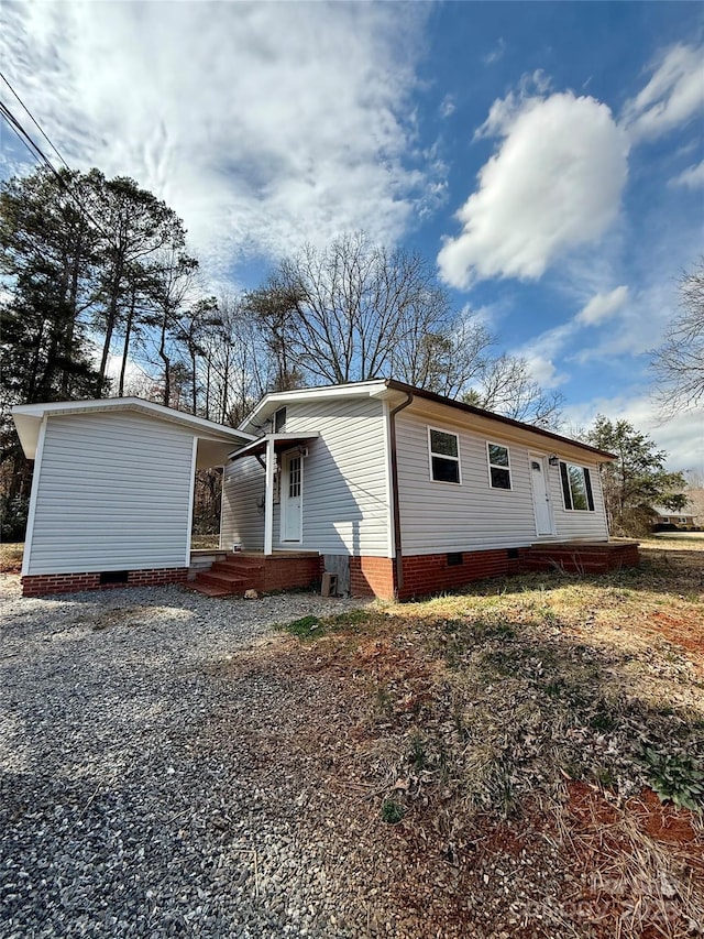 exterior space featuring crawl space and driveway