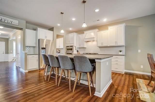 kitchen featuring visible vents, backsplash, stainless steel appliances, and custom range hood