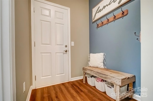 mudroom featuring baseboards and wood finished floors