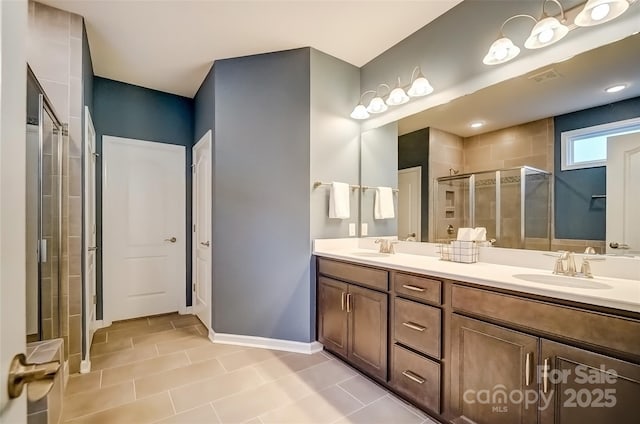 full bath featuring a shower stall, double vanity, visible vents, and a sink