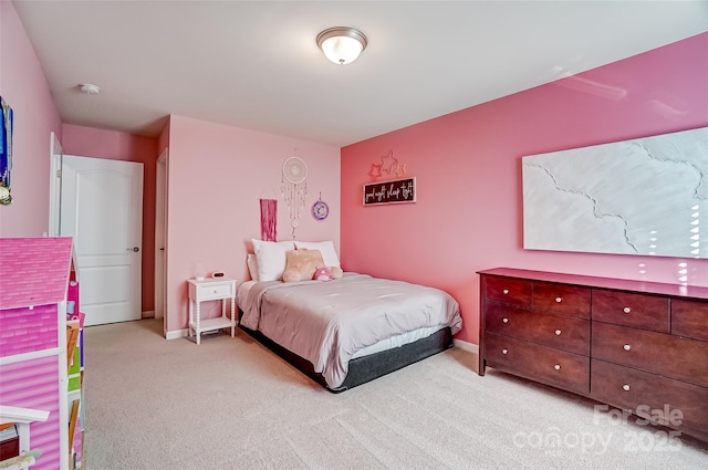 bedroom featuring light colored carpet and baseboards