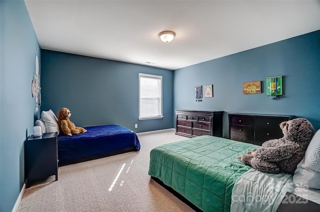 bedroom featuring baseboards, visible vents, and carpet floors