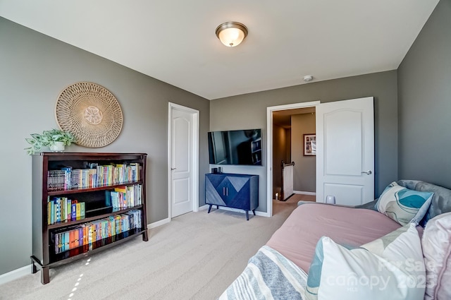 bedroom with baseboards and carpet