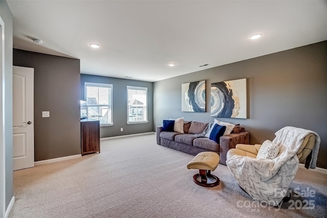 living area featuring visible vents, recessed lighting, light colored carpet, and baseboards