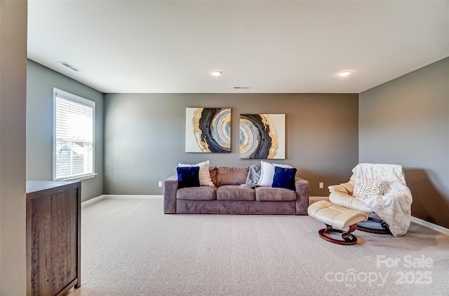 carpeted living area featuring recessed lighting, baseboards, and visible vents