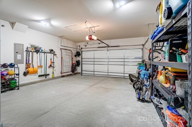 garage featuring electric panel and a garage door opener