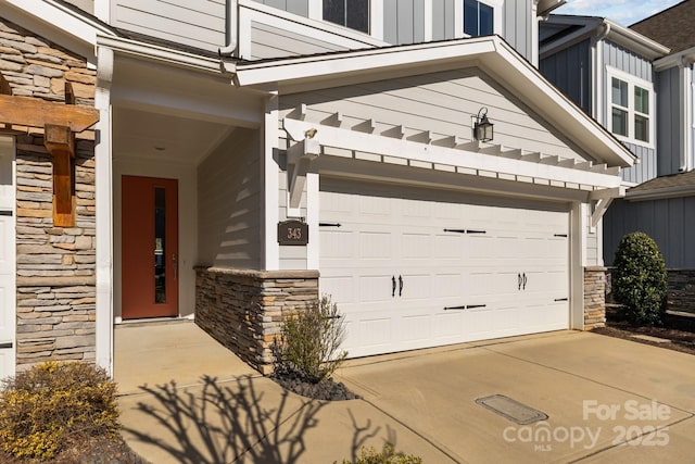 garage featuring concrete driveway