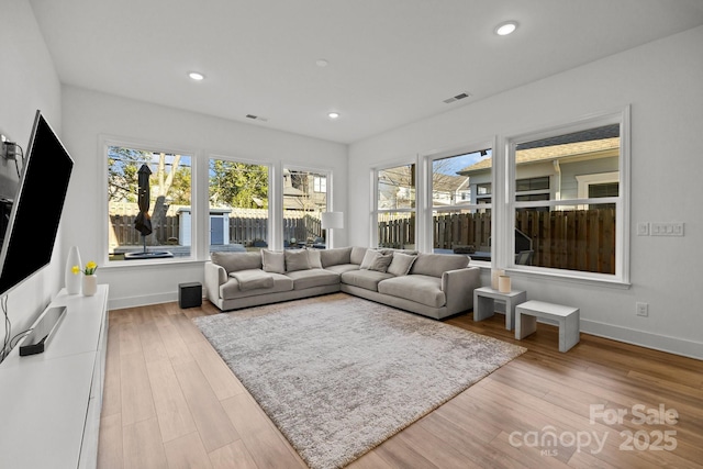 interior space with recessed lighting, visible vents, baseboards, and wood finished floors