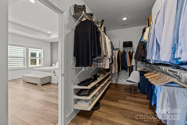 spacious closet with wood finished floors and visible vents