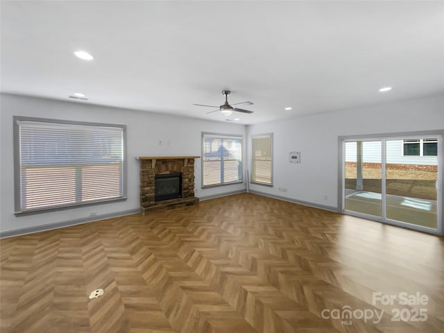 unfurnished living room featuring a fireplace, baseboards, and recessed lighting