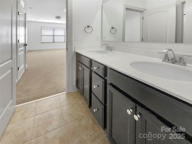 full bathroom with double vanity, a sink, and tile patterned floors