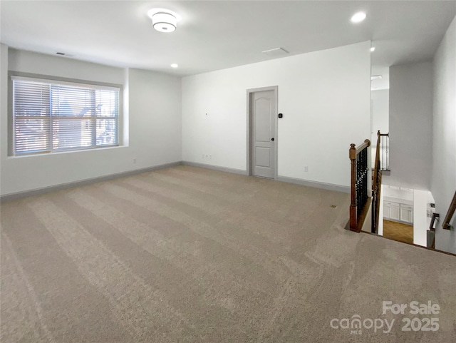 carpeted empty room featuring recessed lighting and baseboards