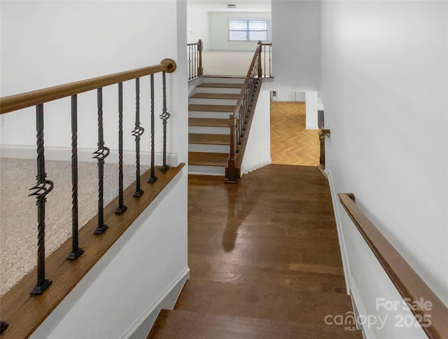 stairs featuring baseboards and wood finished floors