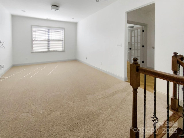 spare room with carpet floors and baseboards