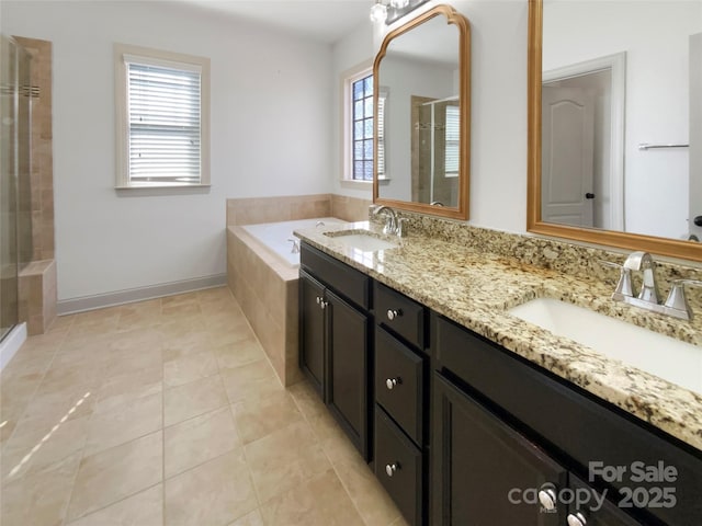 full bathroom with tile patterned floors, a sink, a shower stall, and double vanity