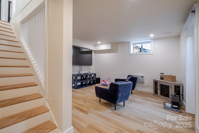 living area with baseboards, stairs, light wood-style flooring, and recessed lighting