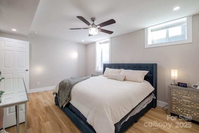 bedroom with multiple windows, recessed lighting, light wood-style flooring, and baseboards
