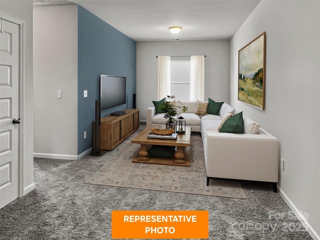 living room featuring carpet flooring and baseboards
