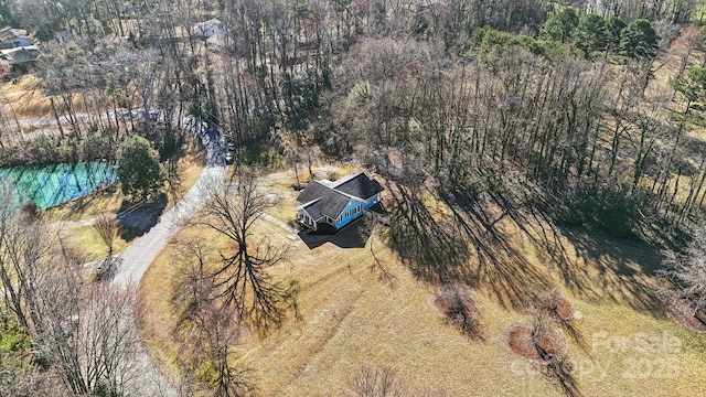 birds eye view of property with a view of trees