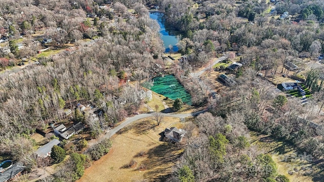 aerial view featuring a view of trees and a water view