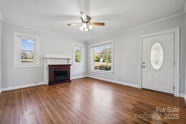 unfurnished living room featuring baseboards, a healthy amount of sunlight, hardwood / wood-style floors, and a fireplace