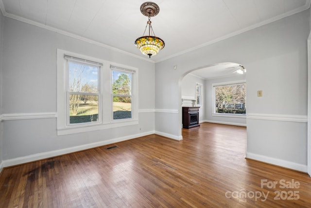 unfurnished living room featuring visible vents, a fireplace, baseboards, and wood finished floors