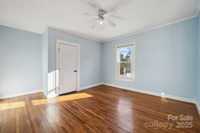 unfurnished room with hardwood / wood-style flooring, baseboards, visible vents, and ornamental molding