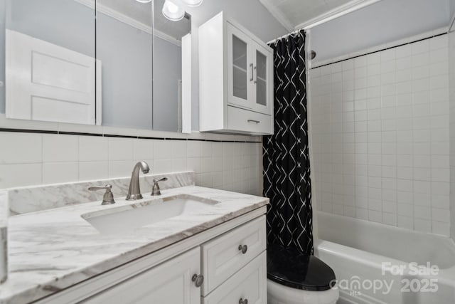 bathroom featuring vanity, ornamental molding, toilet, tasteful backsplash, and shower / tub combo with curtain