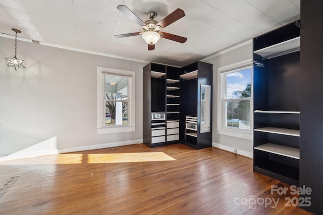 interior space with ceiling fan and wood finished floors