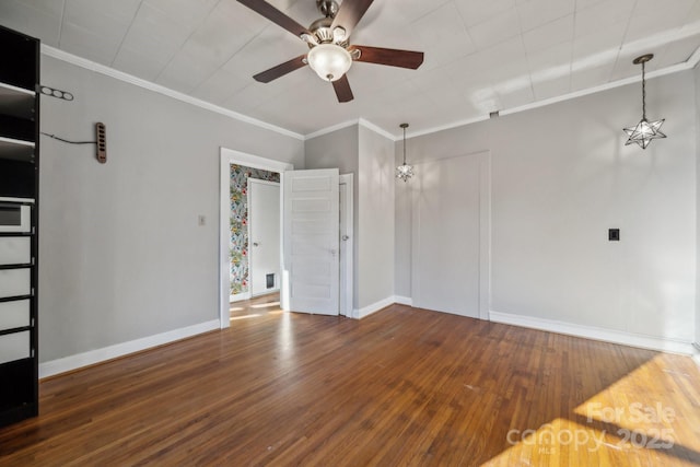 unfurnished room featuring visible vents, crown molding, ceiling fan, baseboards, and wood finished floors