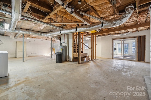 basement featuring washer / clothes dryer and electric water heater