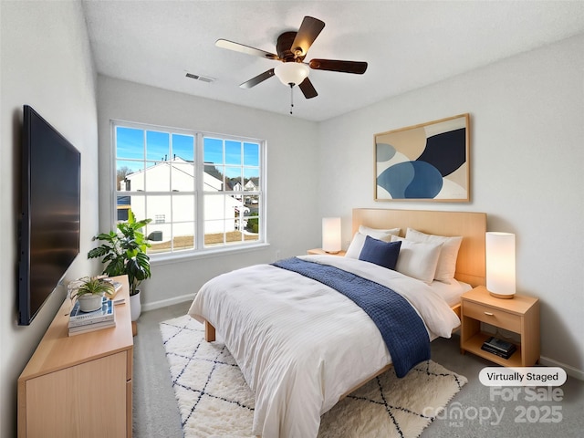 bedroom featuring carpet floors, a ceiling fan, visible vents, and baseboards