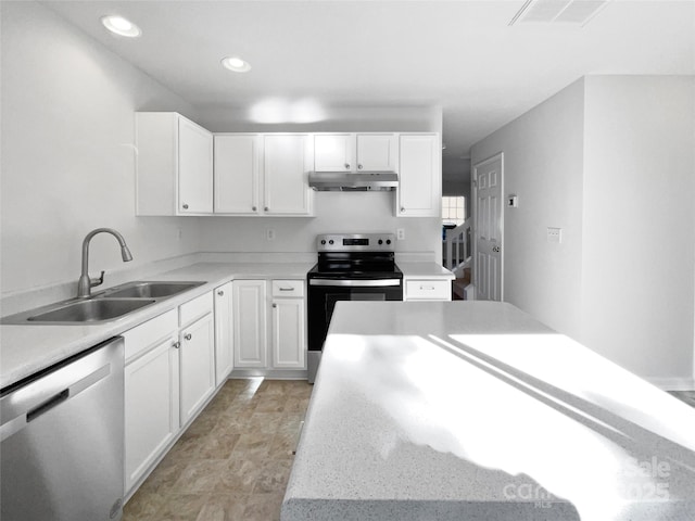 kitchen featuring visible vents, white cabinets, stainless steel appliances, under cabinet range hood, and a sink