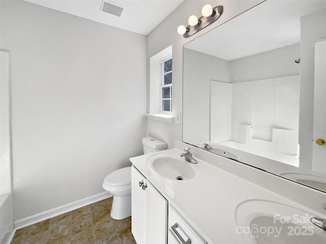 bathroom featuring visible vents, a sink, and toilet