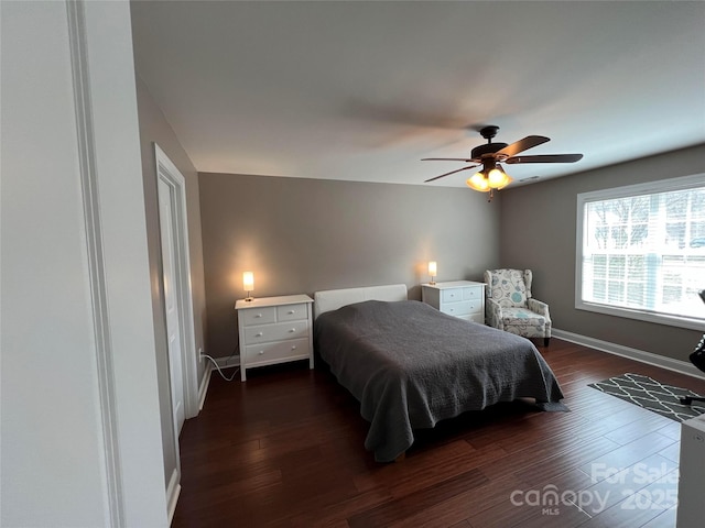 bedroom featuring ceiling fan, baseboards, and dark wood-type flooring