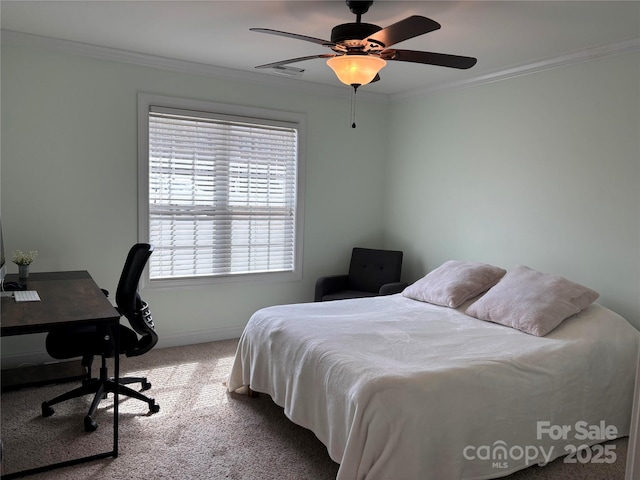 carpeted bedroom with baseboards, visible vents, ornamental molding, and a ceiling fan