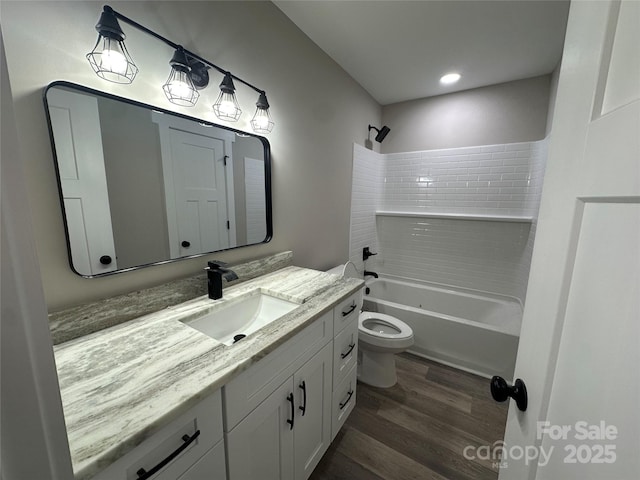 bathroom with vanity, shower / bathing tub combination, wood finished floors, and toilet