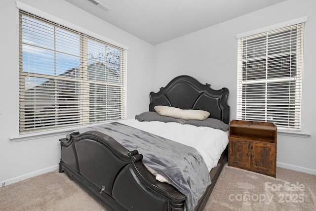 bedroom featuring baseboards, visible vents, and carpet flooring